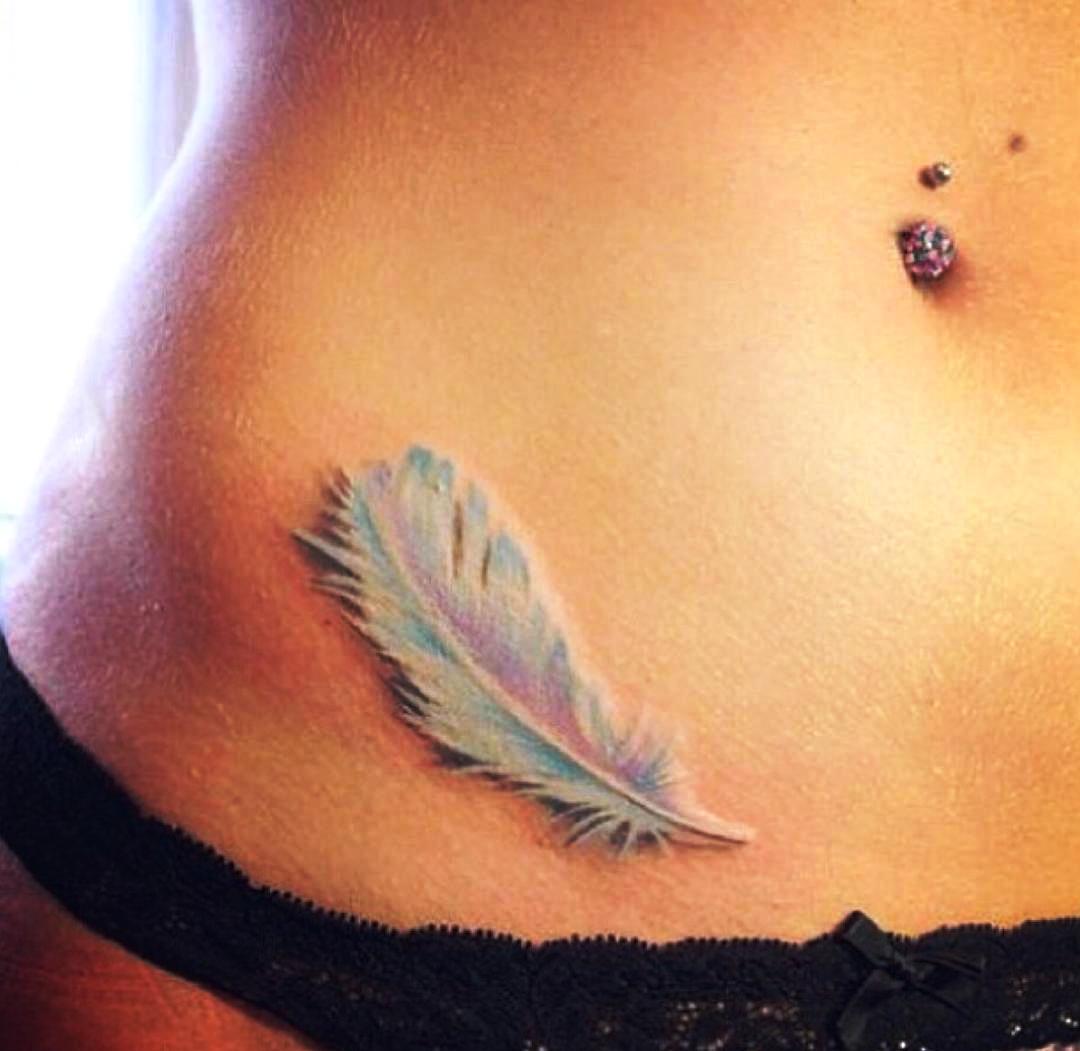 Feather tattoo close to the hip