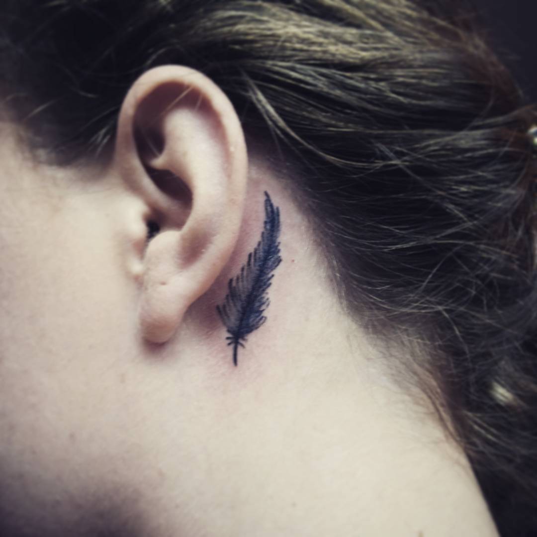 Feather tattoos behind ears