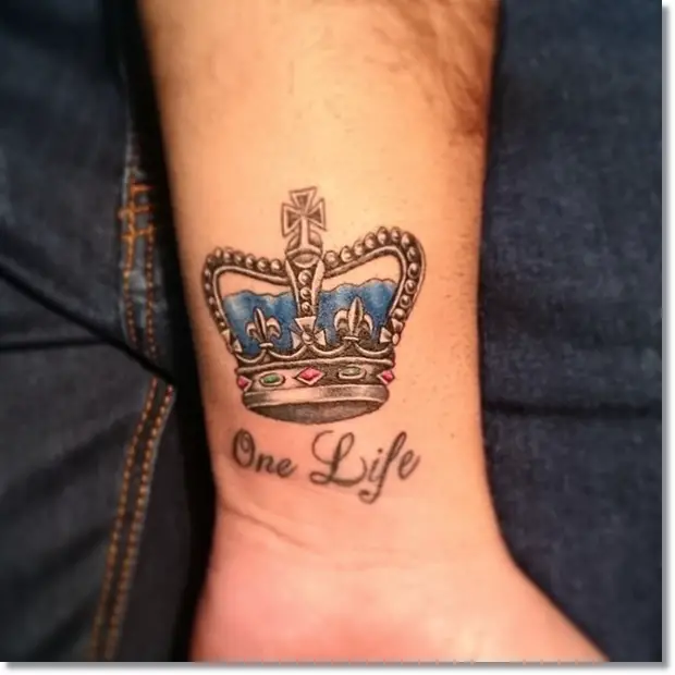 Small crown tattoo on wrist with quote