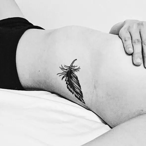 cute small feather tattoo on ribs