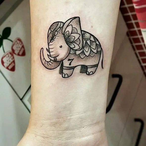 little elephant tattoo on wrist