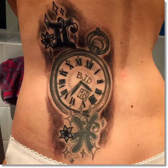 pocket watch tattoo for women on lower back