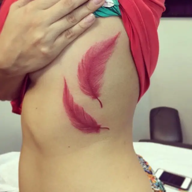 red feathers tattoo ideas on ribs