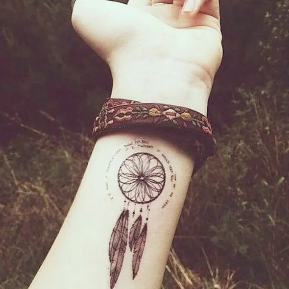 small dream catcher wrist tattoo