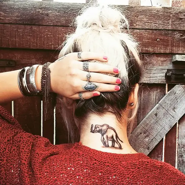 small elephant tattoo behind neck