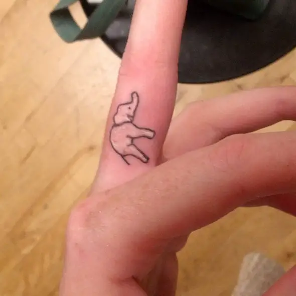 small elephant tattoo on finger