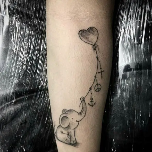 small elephant with symbols tattoo