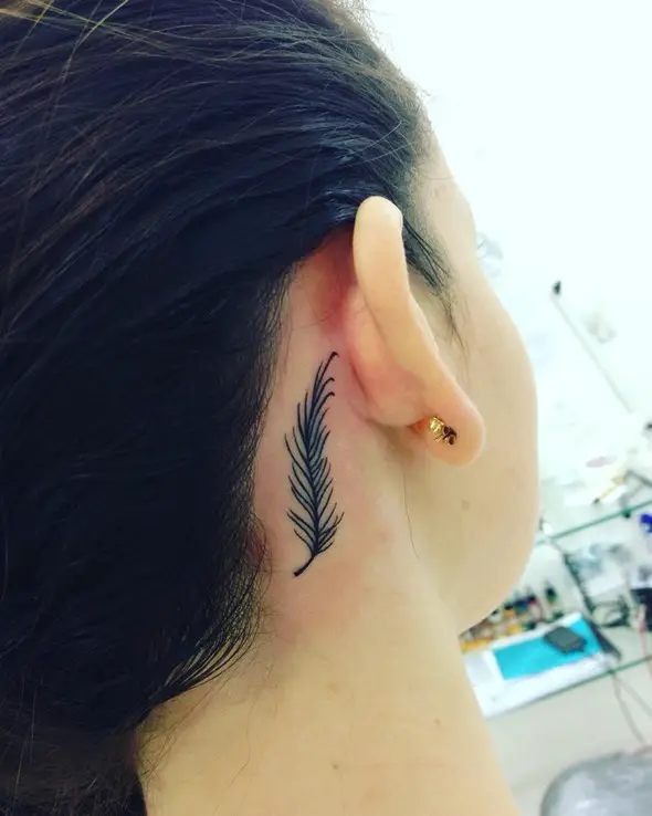 small feather tattoo behind ear