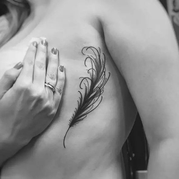 small feather tattoo on side