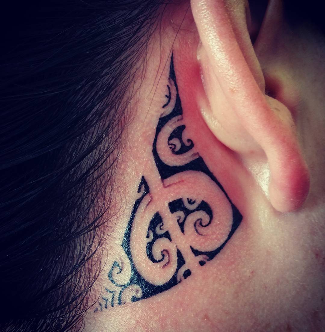 small Hawaiian tattoo behind ear