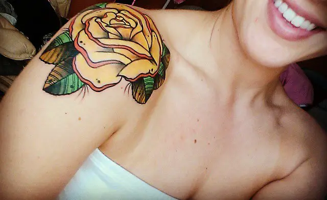 small rose tattoo on shoulder