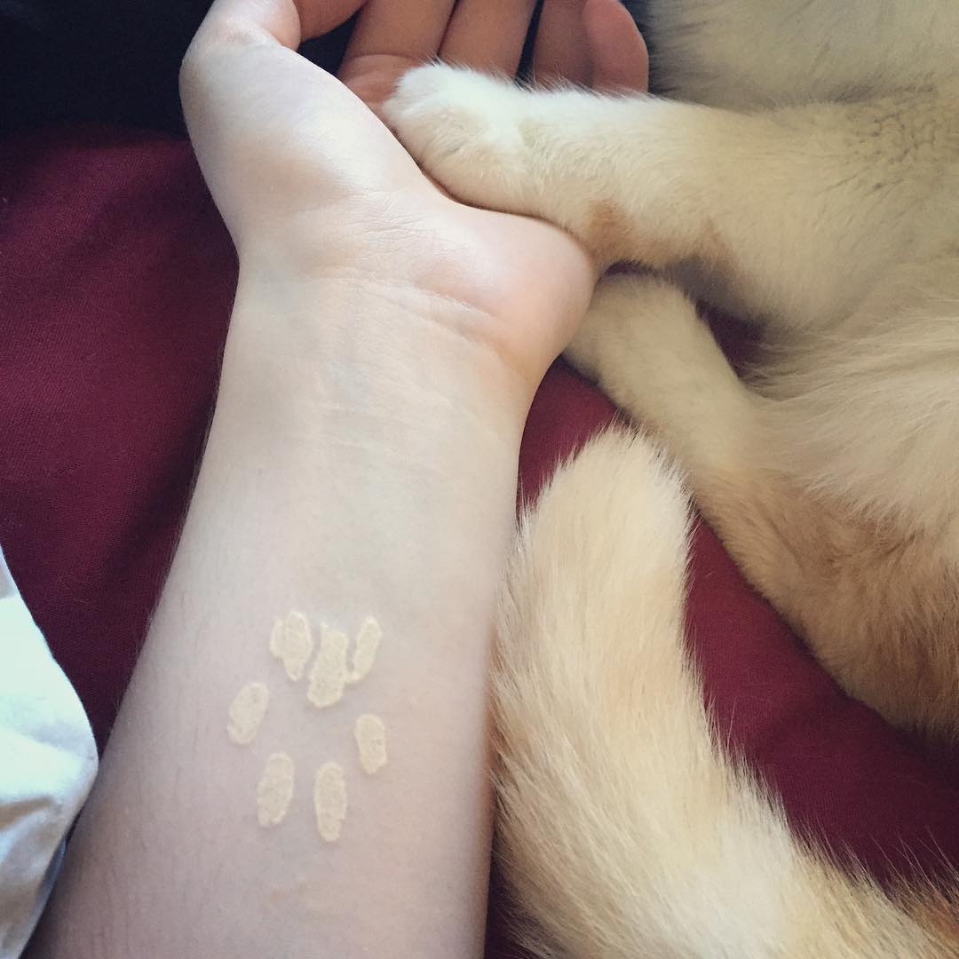 white ink paw print tattoo