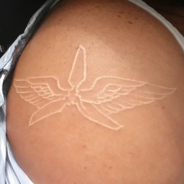 White ink aviation tattoo