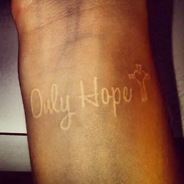 Only hope cross white ink tattoo on wrist