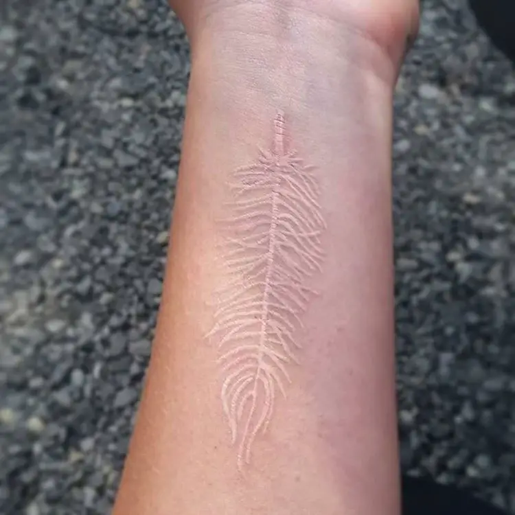 White ink feather tattoo