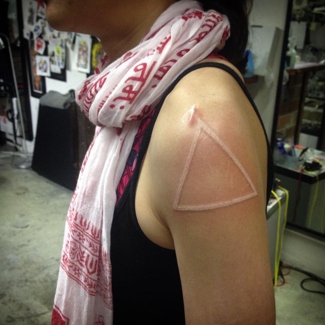 white ink triangle tattoo