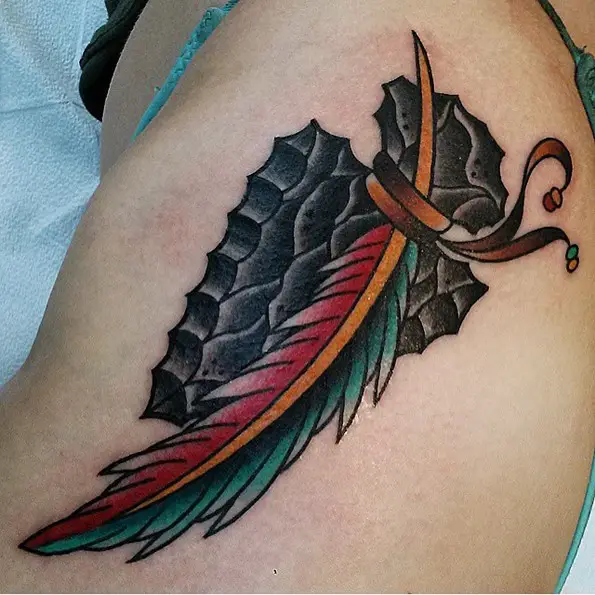 Cool arrowhead feather tattoo on thigh