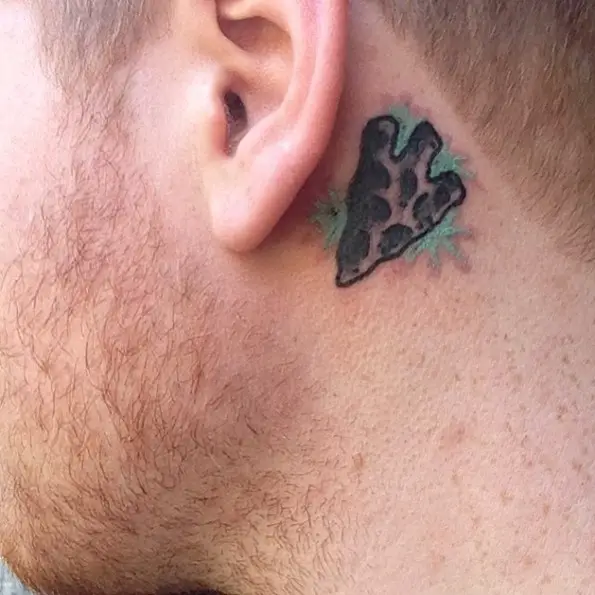 arrowhead behind the ear tattoo