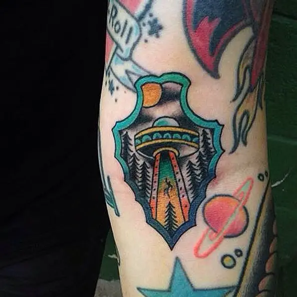 arrowhead tattoo with flying UFO inside