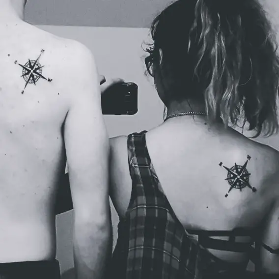 his and hers matching compass back tattoos