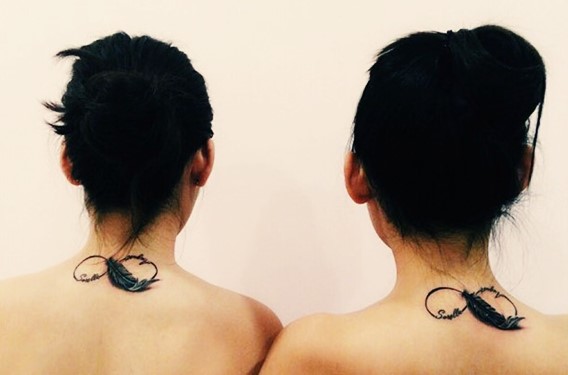 matching sisters infinity feather tattoo on back