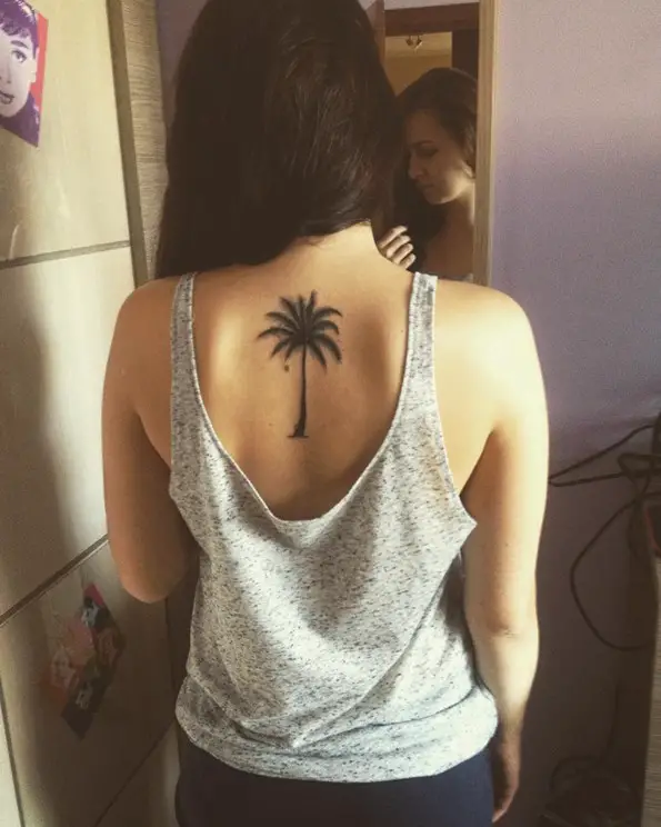 smal palm tree tattoo on back