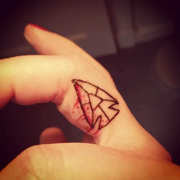 tiny arrowhead finger tattoo