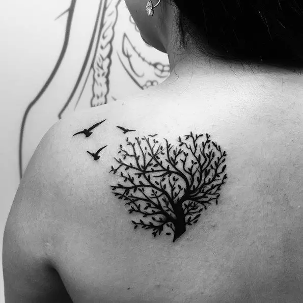 tree tattoo with bird on back