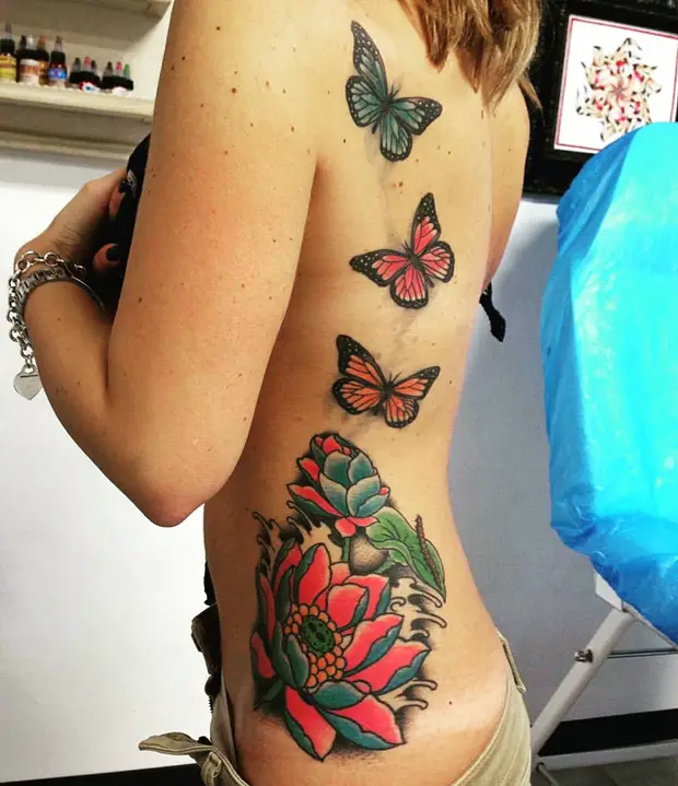 side tattoos female butterflies
