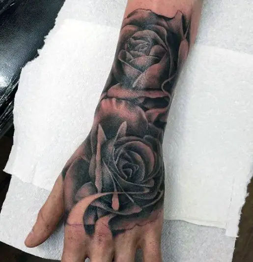 Black rose tattoo on hand