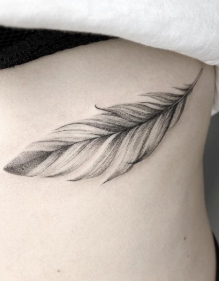 delicate feather tattoo