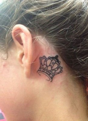 Small crown tattoos behind ear